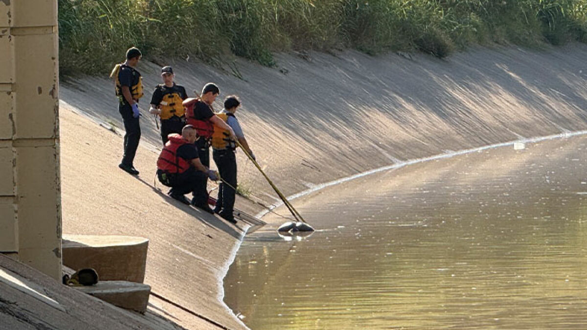 Search and rescue team in life vests investigating water canal amid fears of serial criminal rise in Houston.