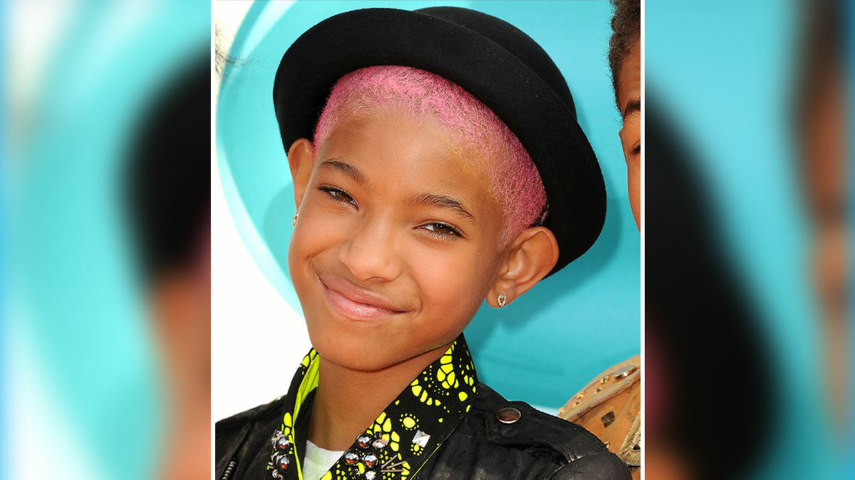 Willow Smith with pink shaved hair and black hat smiling, linked to fans heartbroken after mid-tour reveal