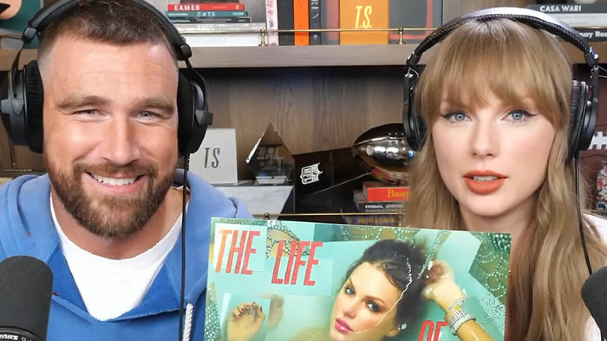 Taylor Swift and Travis Kelce wearing headphones and holding autographed Taylor Swift albums in a podcast studio.