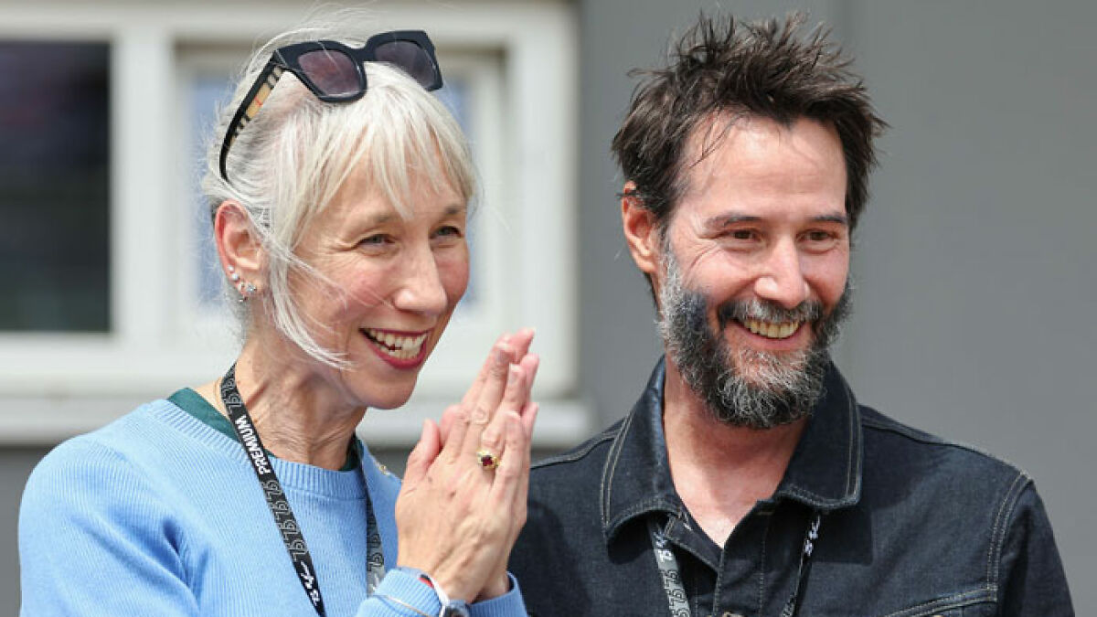 Keanu Reeves smiling with Alexandra Grant, addressing marriage rumors and public speculation about their relationship.
