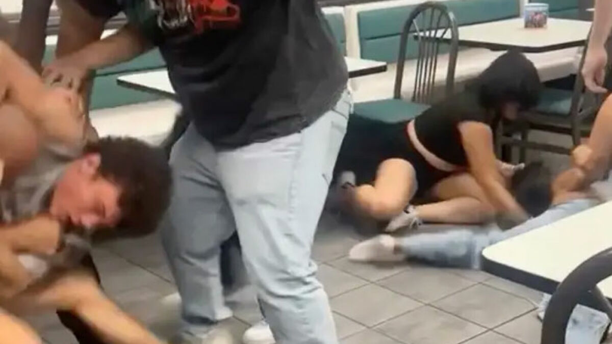 Mass brawl erupts inside Whataburger with multiple people on the floor in a violent conflict over a wrong order.