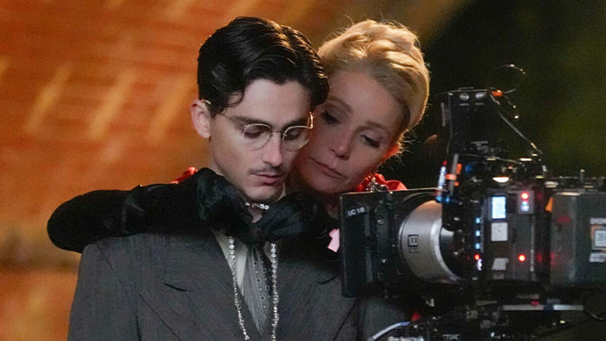 Gwyneth Paltrow and Timothu00e9e Chalamet on set with a professional camera, highlighting a tense moment amid big news.