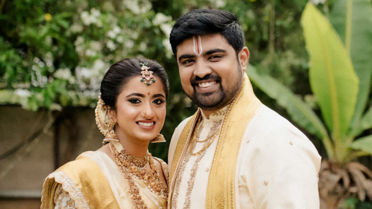 Smiling couple dressed in traditional attire posing outdoors, related to doctor who argued against wifeu2019s autopsy case.