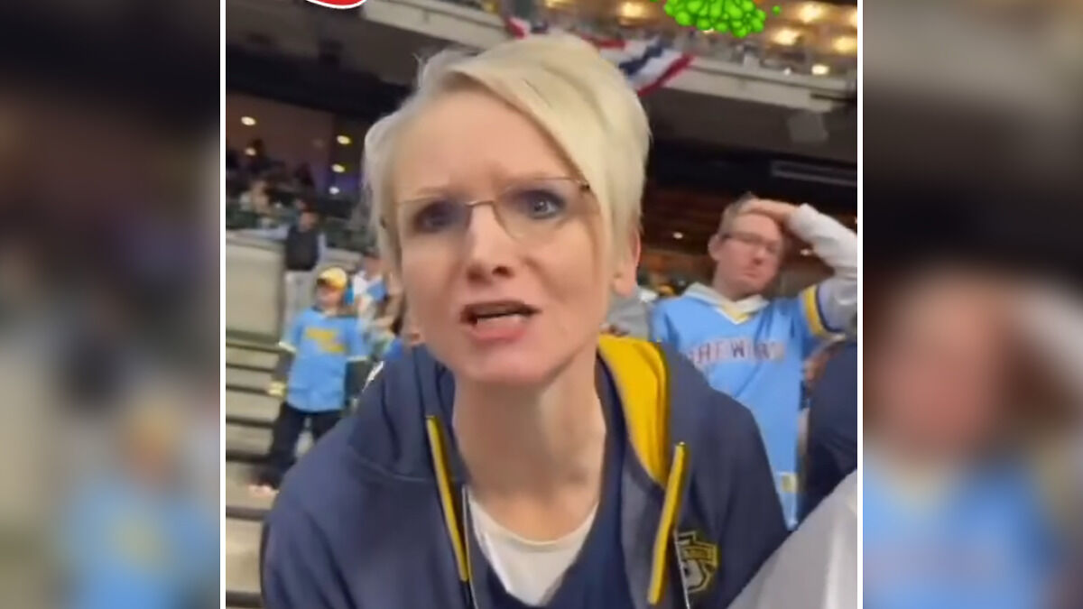 Woman at baseball game angrily ranting, crowd in background, related to baseball Karen fired after racist rant at war veteran.