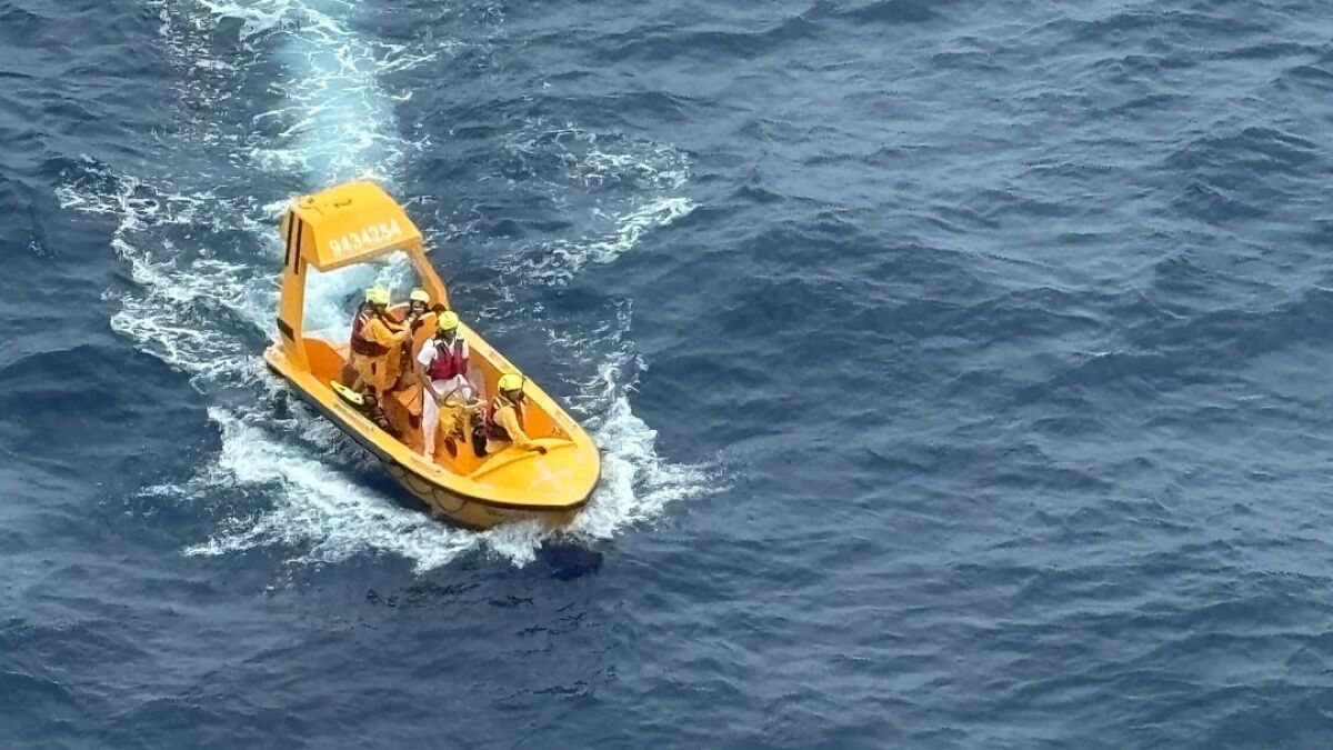 Rescue team on a small orange boat navigating the ocean after a girlu2019s terrifying plunge from a Disney cruise ship.
