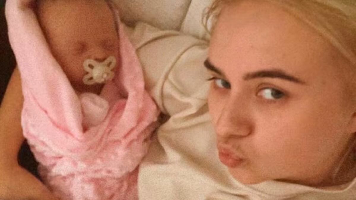 Woman holding a doll wrapped in pink blanket, highlighting outrageous 10-month lie about baby discovery by family.