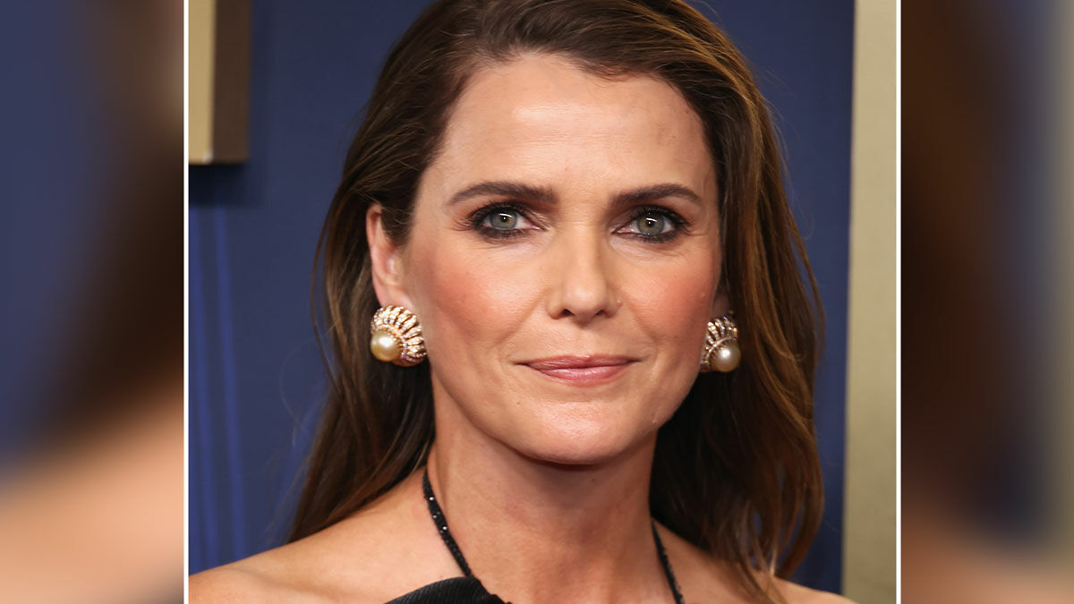 Keri Russell close-up wearing pearl earrings and black dress, addressing Hollywoodu2019s growing plastic surgery trend.