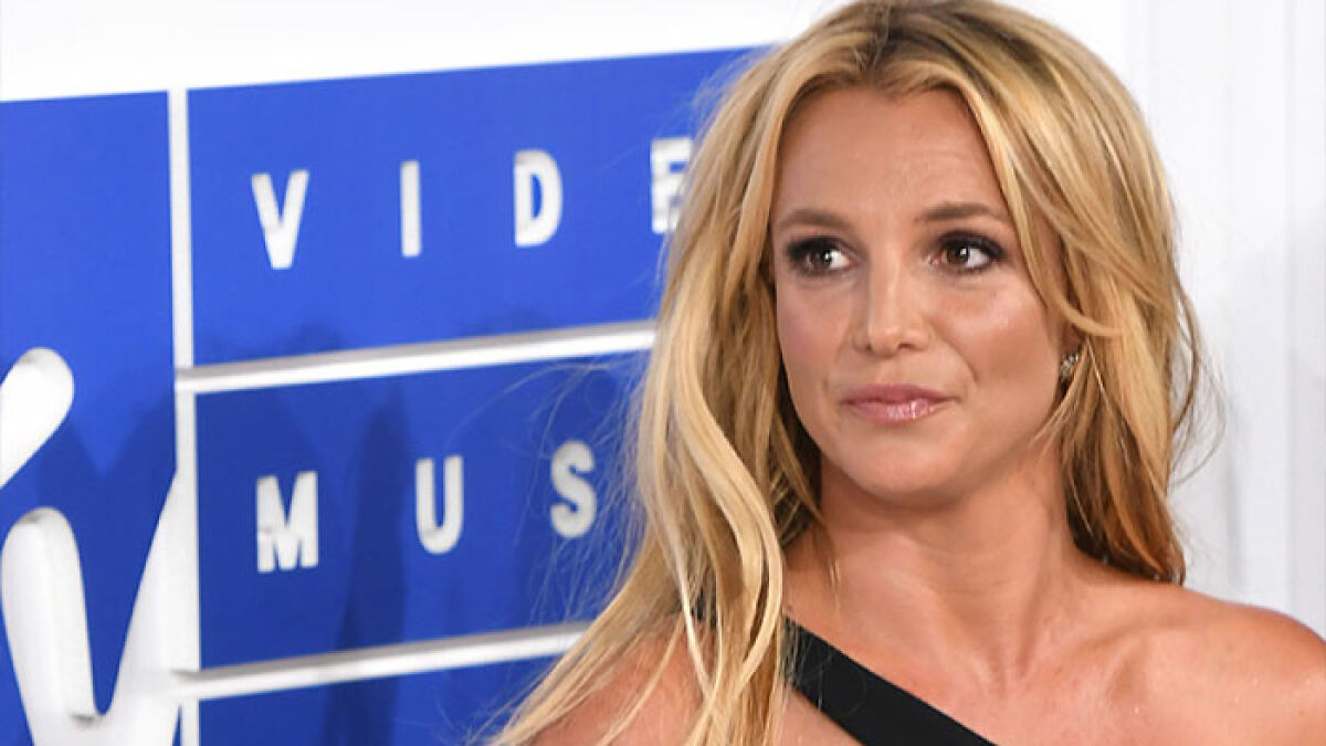 Britney Spears attending a public event with a serious expression amid brain damage confession news.