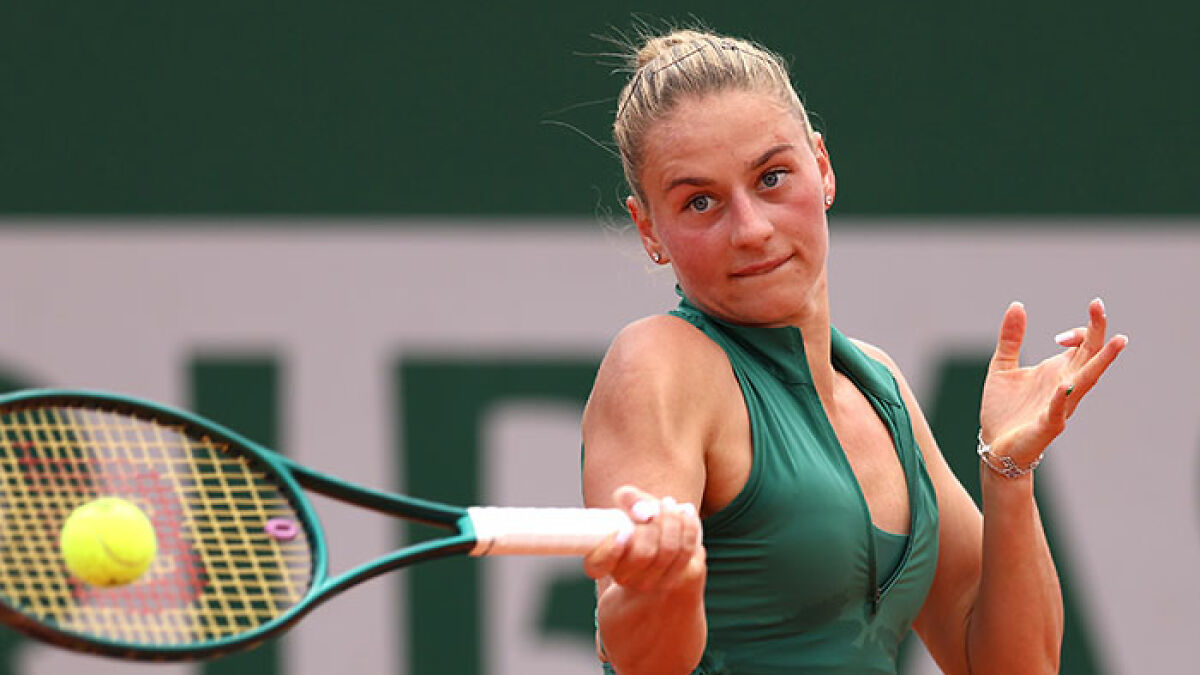 Female tennis star hitting a forehand shot during a match, highlighting athleticism and the tennis rivalry controversy.