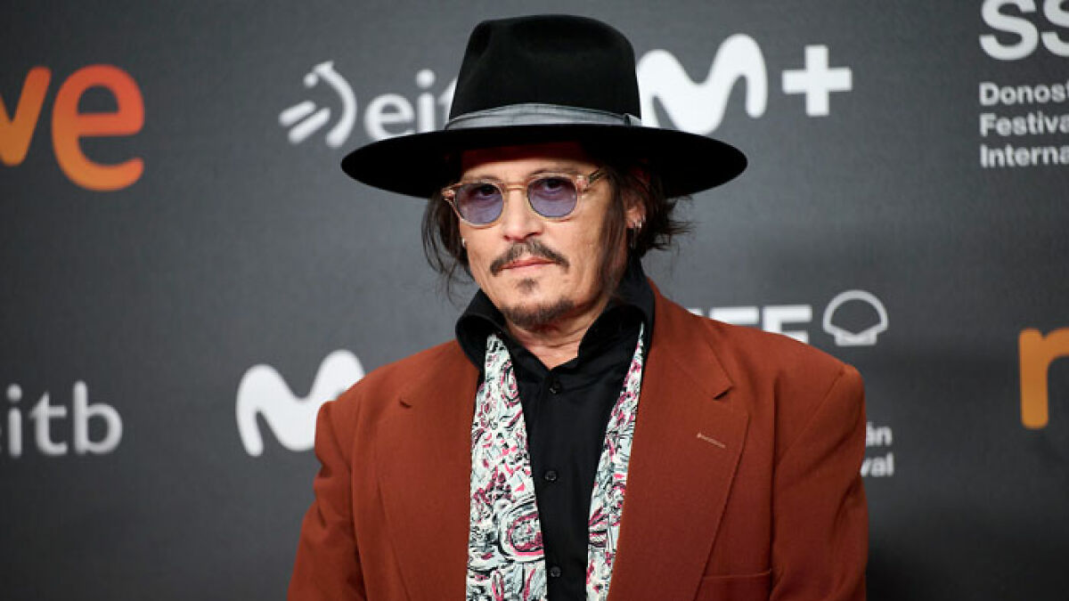 Johnny Depp wearing a black hat and brown jacket at a film festival, linked to new movie role backlash.