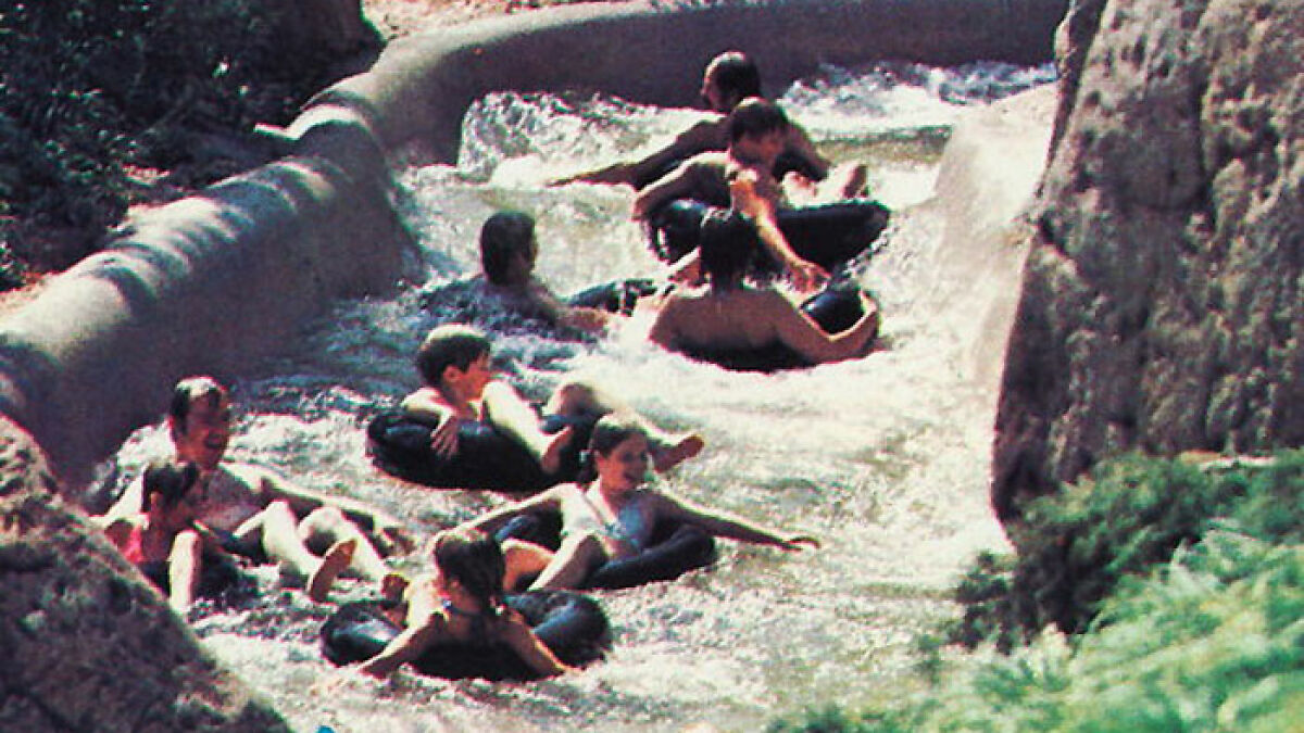 Visitors riding a water slide at Disney World, illustrating moments related to tragic incidents at the park.