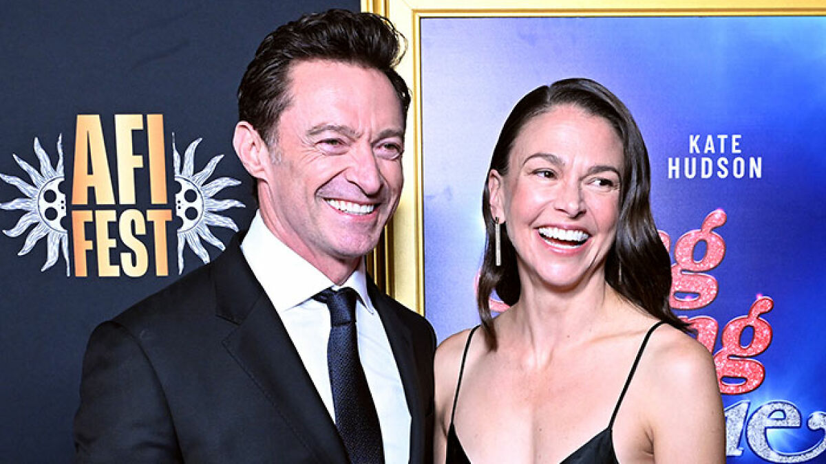Hugh Jackman and Sutton Foster smiling on the red carpet amid midlife crisis fan reactions at AFI Fest.