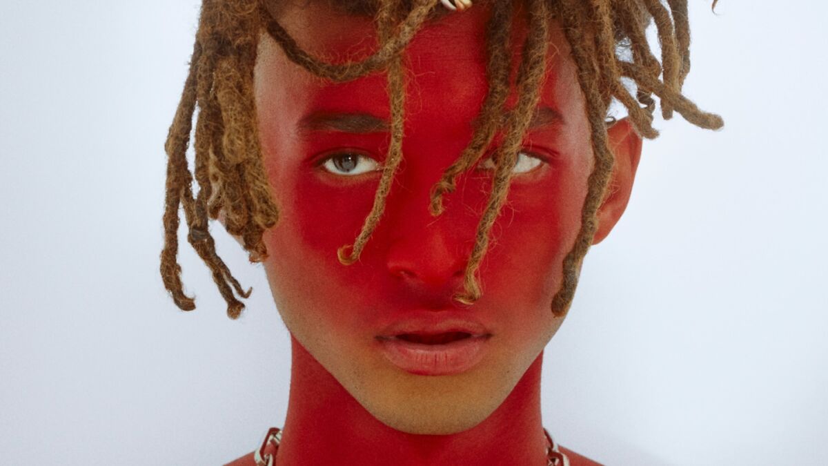 Close-up portrait of a nepo baby with red face paint and dreadlocks, representing Hollywoodu2019s new generation.