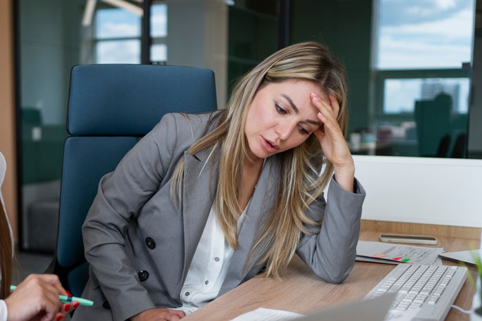 Stressed woman in office upset after coworker snoops around in her purse and causes trouble at work Stressed woman in office upset after coworker snoops around in her purse and causes trouble at work