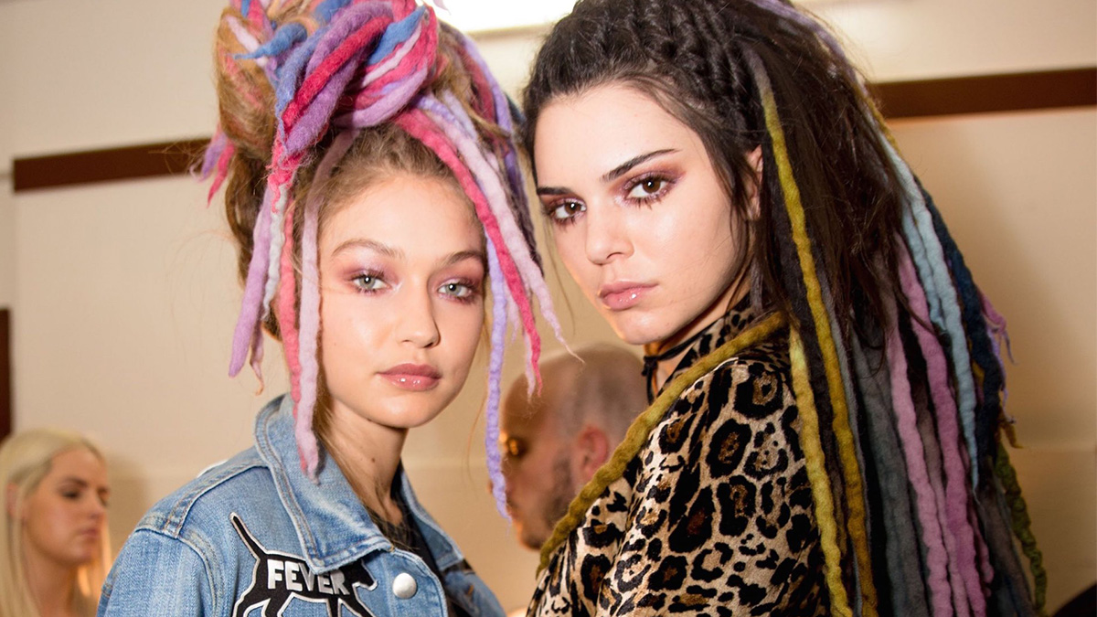 Two stylish young women with colorful dreadlocks posing, highlighting girly friendships and relatable fashion moments.