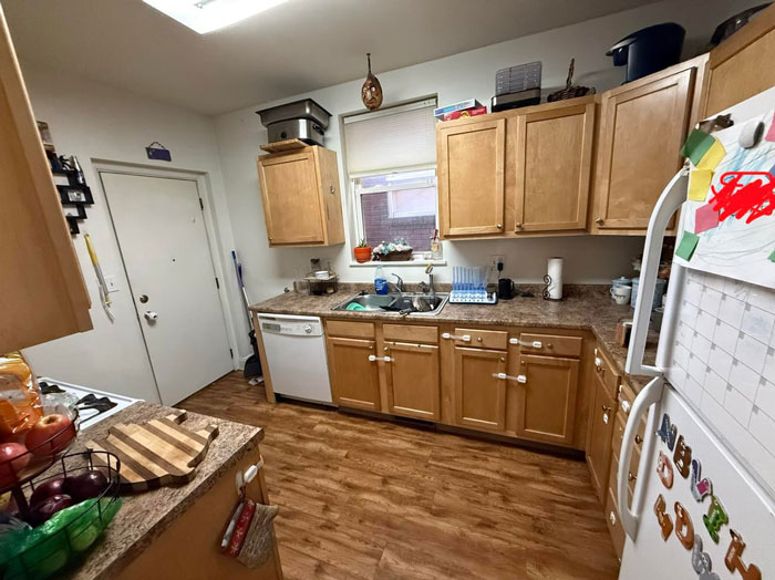 Kitchen with toddler-proofed cabinets and everyday clutter, highlighting exhausted mom’s battle for a spotless house. Kitchen with toddler-proofed cabinets and everyday clutter, highlighting exhausted mom’s battle for a spotless house.