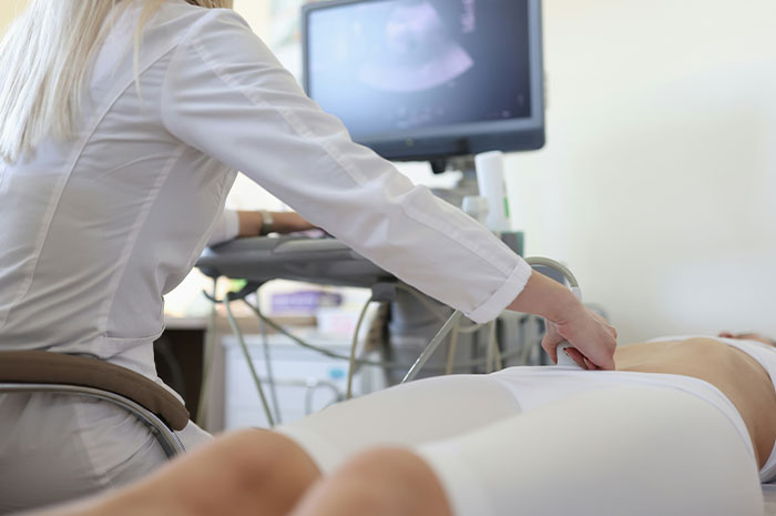 Medical professional performing an ultrasound as patients often google symptoms before seeing a doctor for diagnosis and care.