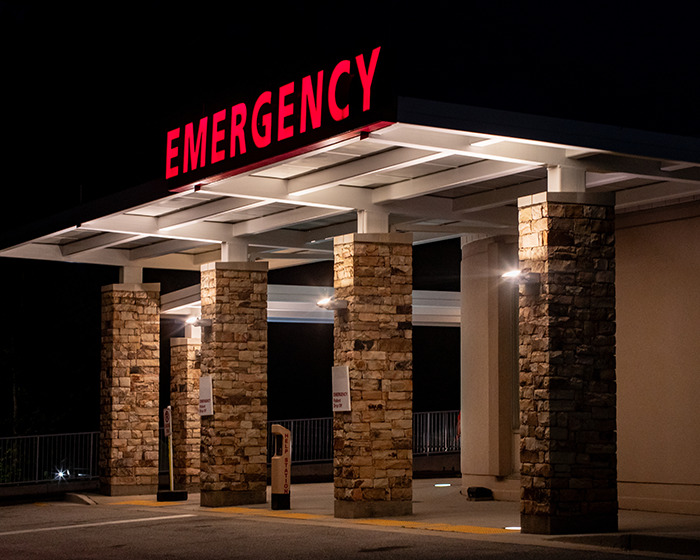 Emergency entrance at night symbolizing thousands visiting ER due to avocado hands injury warning from doctors. Emergency entrance at night symbolizing thousands visiting ER due to avocado hands injury warning from doctors.