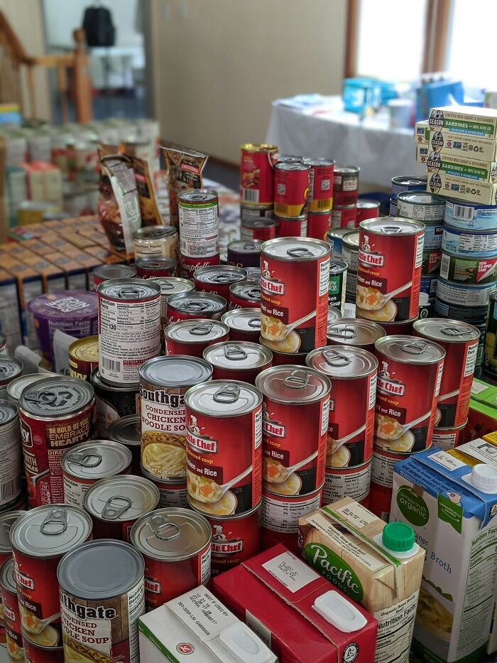 Canned food and supplies stacked on a table inside a stranger’s home showing weird things workers have seen.