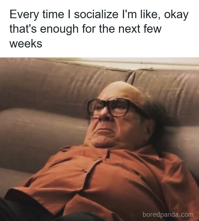 Man lying on couch with glasses and anxious expression, illustrating relatable memes to help cope with anxiety.