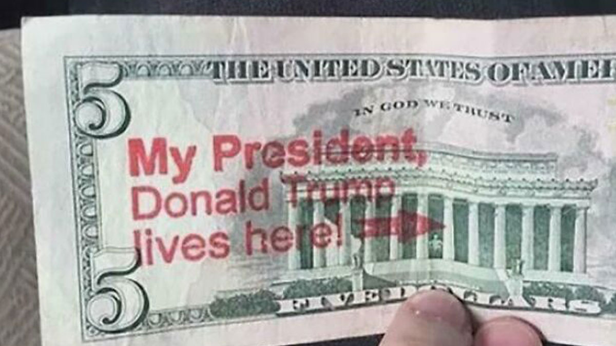 Five dollar bill with incorrect facepalm moment text claiming Donald Trump lives in the Lincoln Memorial building.