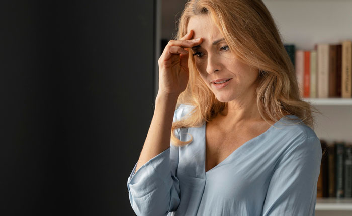 Worried mother reflecting in a room, expressing regret about using daughter as a family scapegoat years later. Worried mother reflecting in a room, expressing regret about using daughter as a family scapegoat years later.