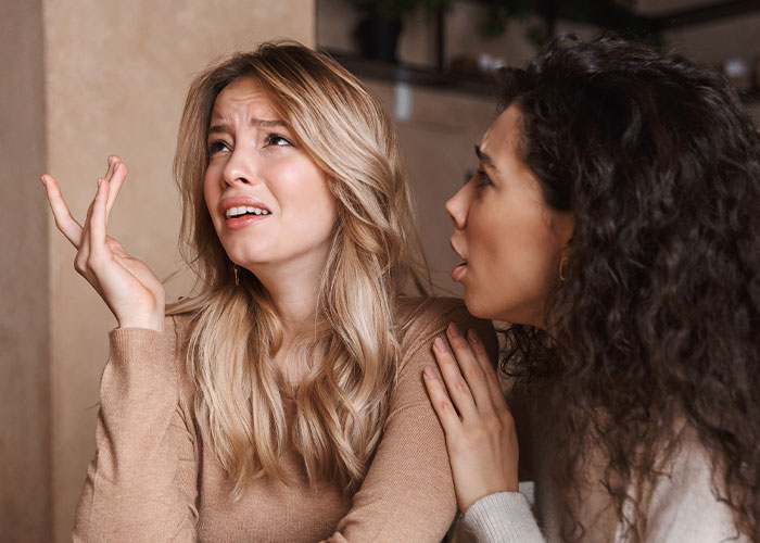 Two women, one upset and the other comforting her, illustrating family separate drive Disneyland challenges and emotions. Two women, one upset and the other comforting her, illustrating family separate drive Disneyland challenges and emotions.