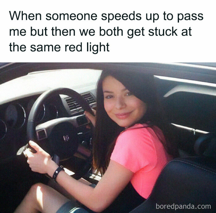 Woman smiling behind the wheel, illustrating a driving meme about road rage and being stuck at the same red light. Woman smiling behind the wheel, illustrating a driving meme about road rage and being stuck at the same red light.