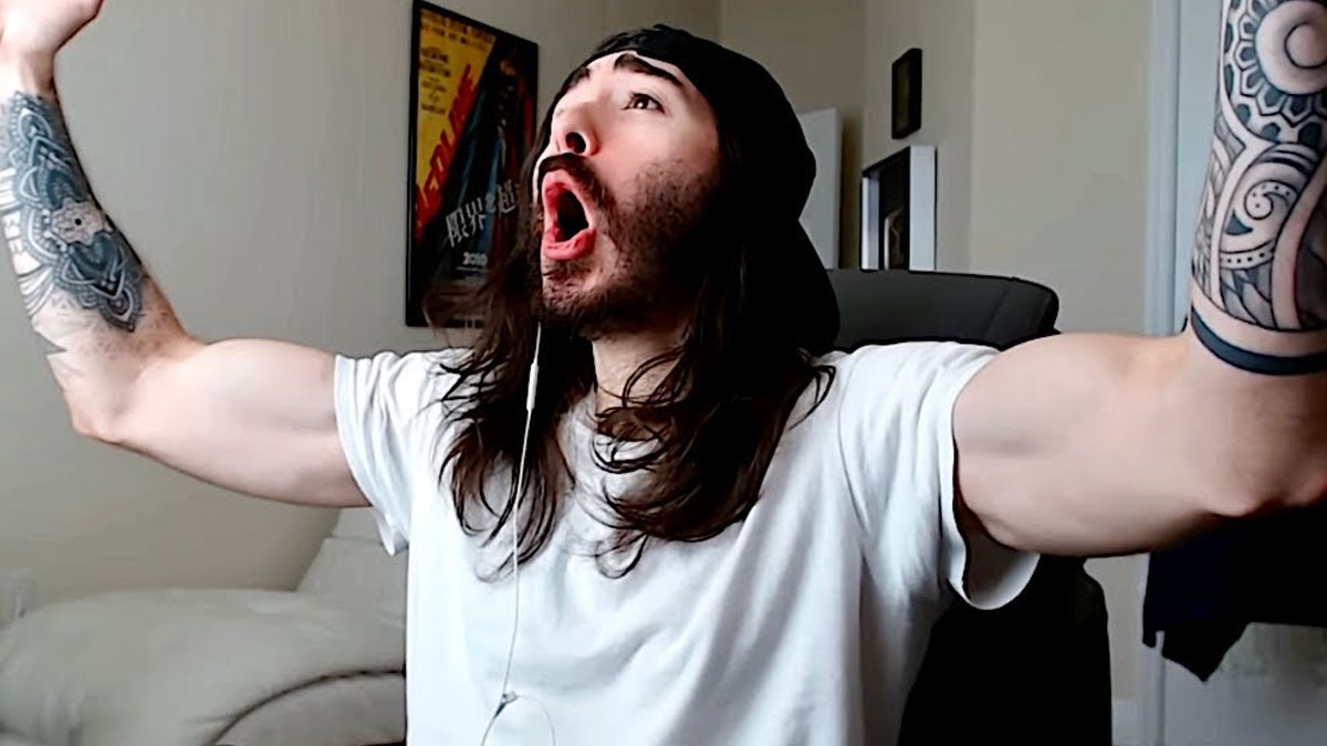 Man with tattoos and long hair reacting excitedly during a Thunder Dungeon meme gaming stream indoors