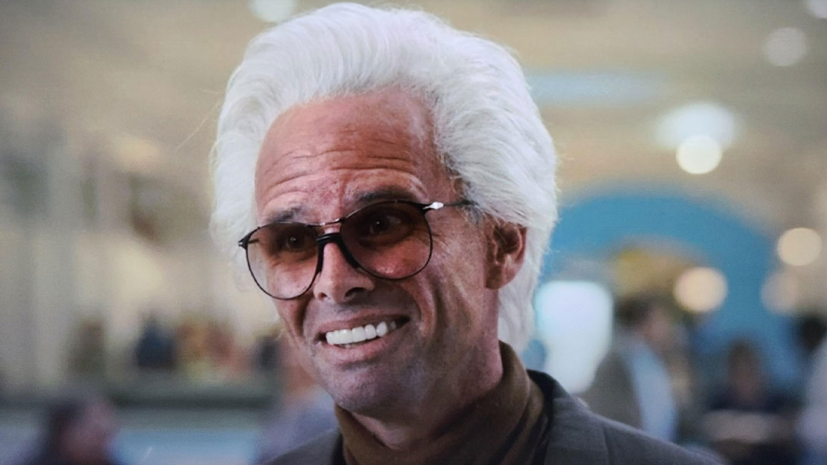 Man with white hair and sunglasses making a confused face, capturing a random and notable moment in TV memes.