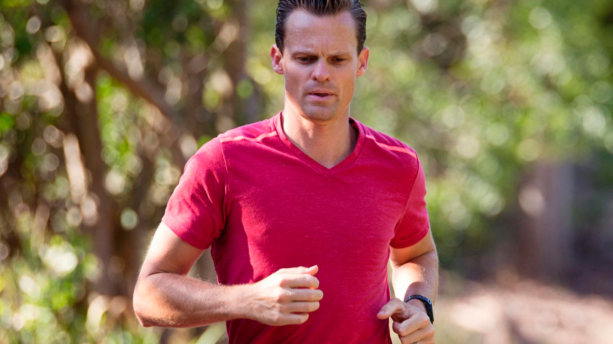 Man running outdoors in a red shirt, illustrating energy and fitness for prime awesome tweets humor theme.