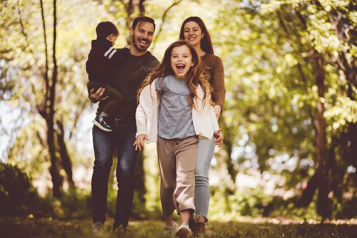 Happy family walking outdoors in a sunlit forest, highlighting emotional struggles and wife pondering ditching husband for good. Happy family walking outdoors in a sunlit forest, highlighting emotional struggles and wife pondering ditching husband for good.