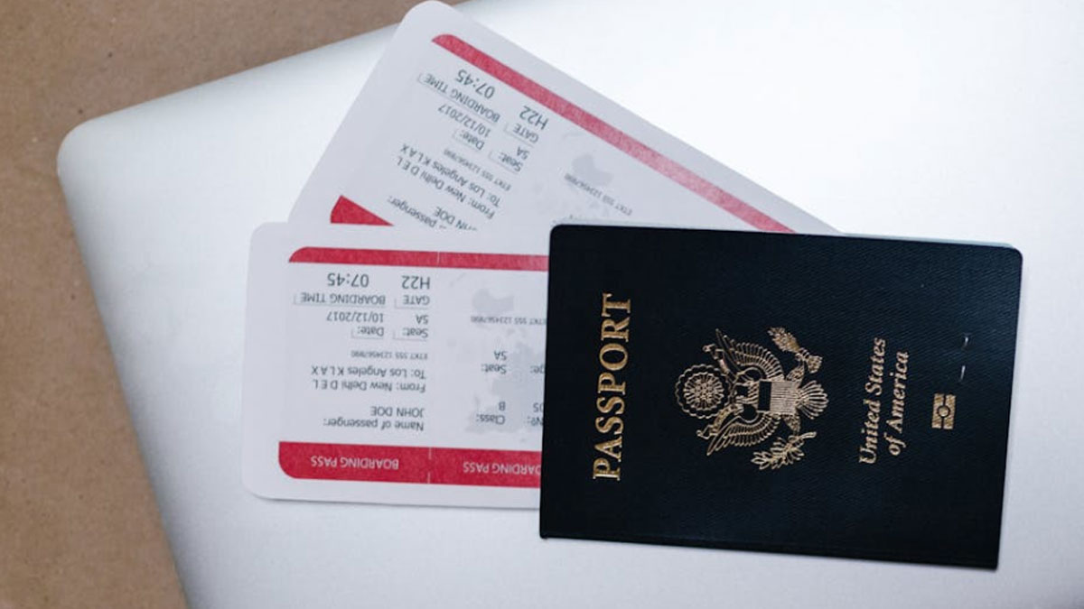 United States passport with boarding passes on a laptop representing travel plans for a cruise trip