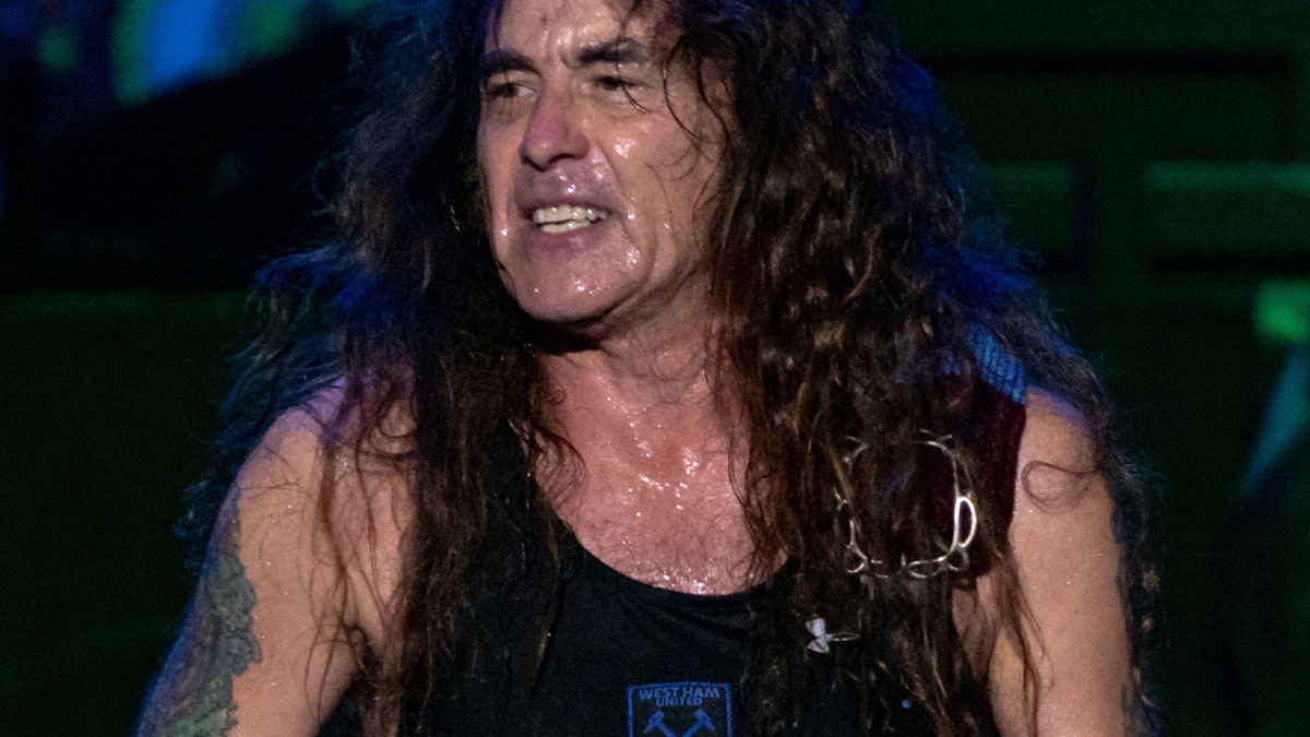 Rock musician performing on stage, sweaty and intense, capturing moments of people with famous family members.