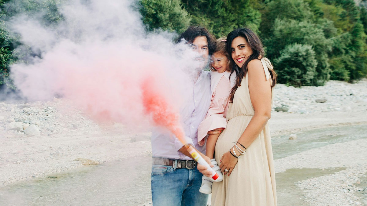 Family holding smoke flare at outdoor wedding, highlighting chaotic moments with wedding guests causing regret.