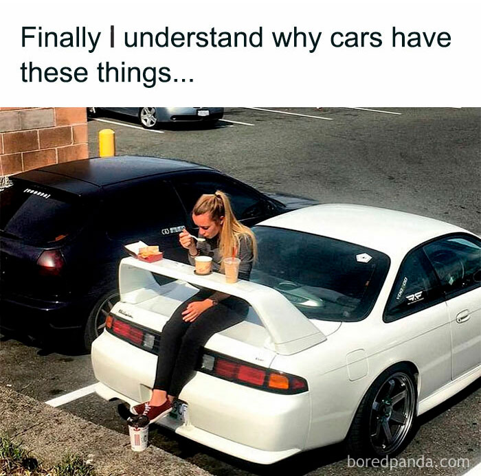 Woman sitting on a car spoiler eating food and drinks, a hilarious and relatable meme about how much work you have to do.