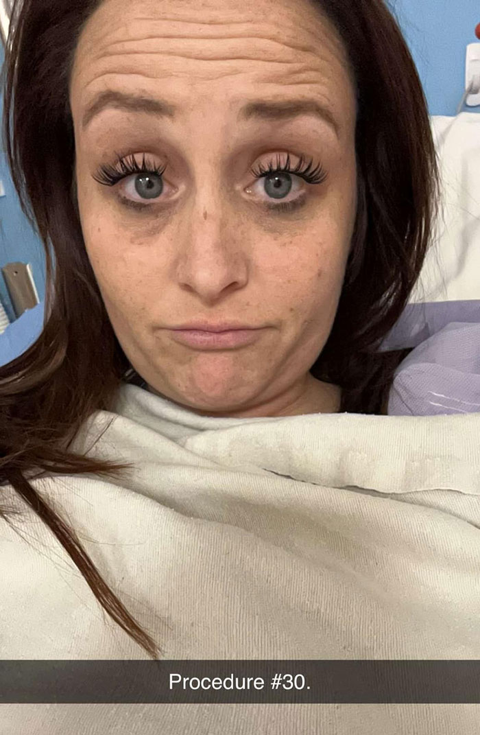 Young mom in hospital bed looking tired and concerned after medical procedure linked to restaurant mistake.