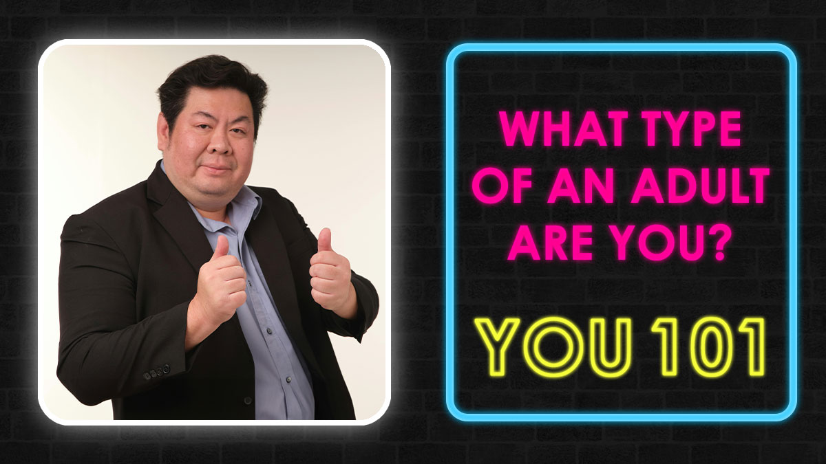 Man in black blazer giving thumbs up next to neon sign asking what type of adult you are in adulthood quiz.