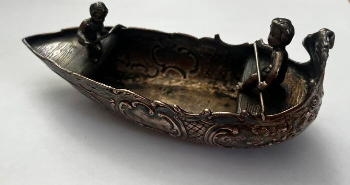 Ornate vintage metal boat figurine with two rowers, an unexpected thing found while cleaning a collection.
