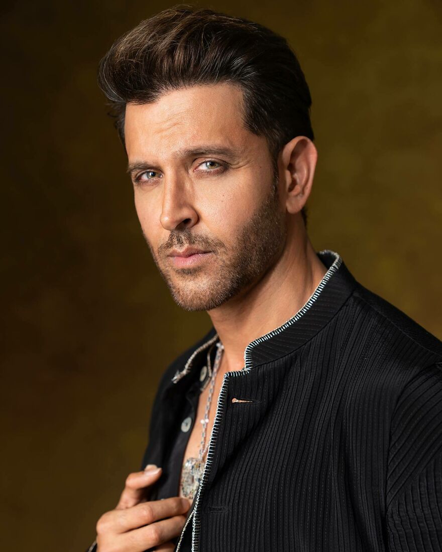 Close-up of a Hrithik Roshan with styled hair and beard wearing a black jacket, representing most handsome man in the world 2025.