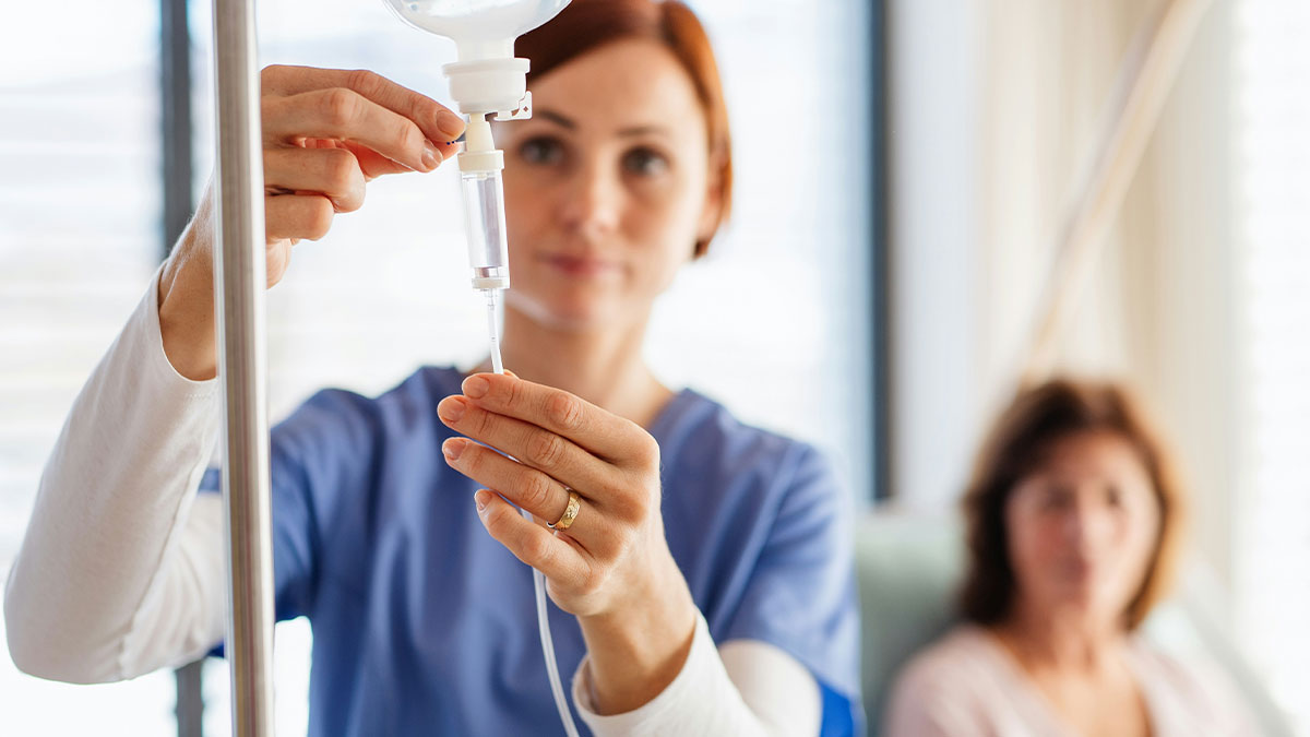 Nurse adjusting IV drip for patient in hospital room, highlighting cases when people self-diagnosed correctly.