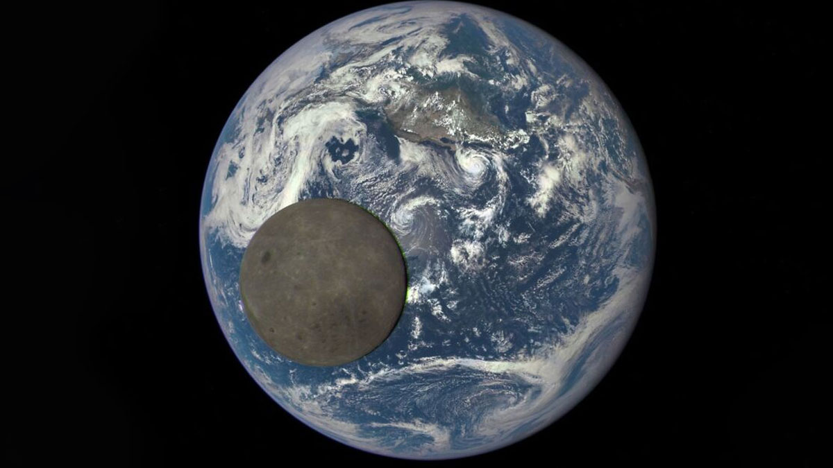 Dark side of the moon in front of Earth showing epic astronomy visuals of space and cosmic beauty.