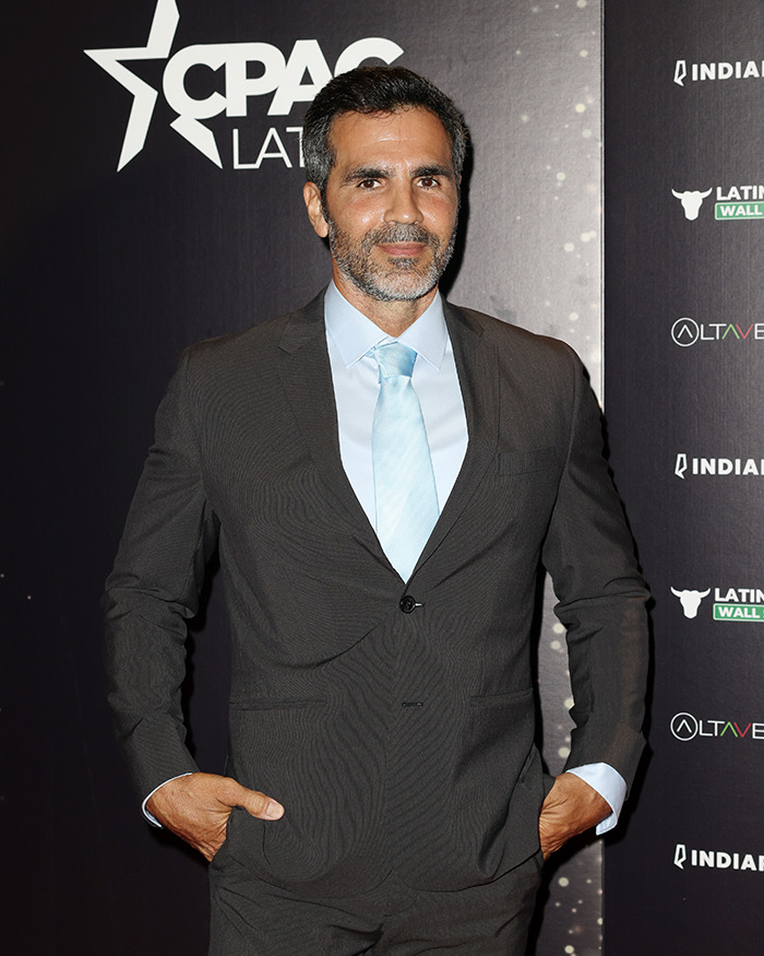 Man in dark suit and light blue tie posing at CPAC Latino event with Jennifer Lopez ex-husband cheating Instagram rant theme. Man in dark suit and light blue tie posing at CPAC Latino event with Jennifer Lopez ex-husband cheating Instagram rant theme.