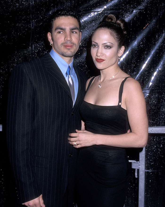 Jennifer Lopez and her ex-husband posing together at a formal event, related to cheating accusations. Jennifer Lopez and her ex-husband posing together at a formal event, related to cheating accusations.