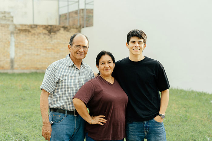 Three family members standing outdoors in a grassy yard, representing a neighbor who found a child and contacted CPS. Three family members standing outdoors in a grassy yard, representing a neighbor who found a child and contacted CPS.