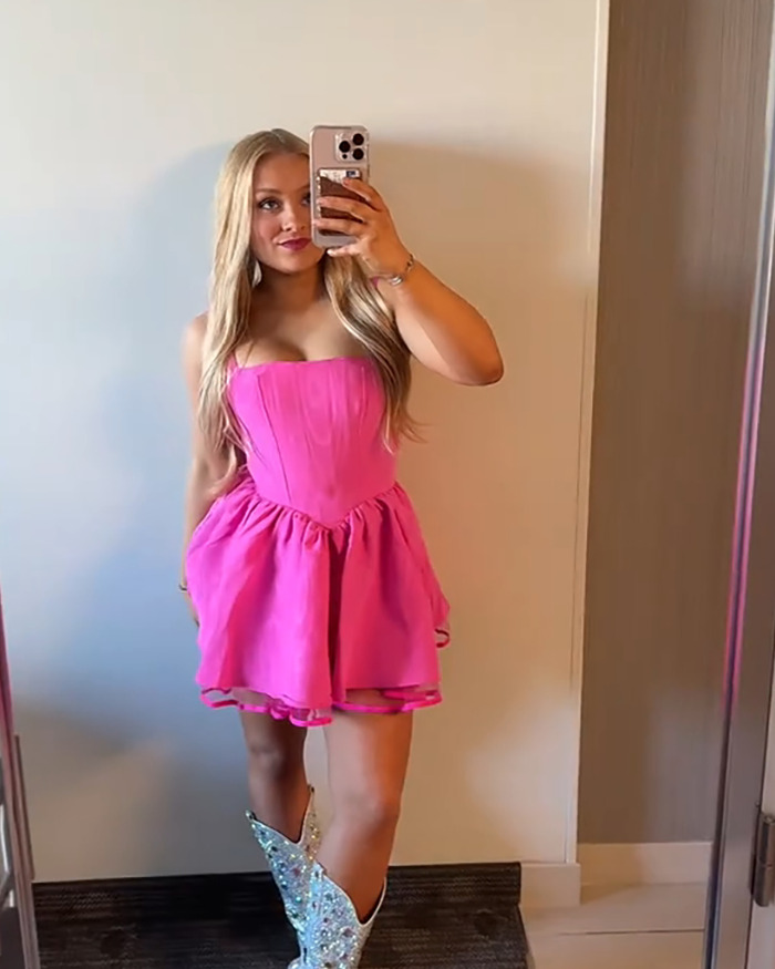 Young woman in a pink dress taking a mirror selfie, related to people furious over judge’s decision in baby case. Young woman in a pink dress taking a mirror selfie, related to people furious over judge’s decision in baby case.