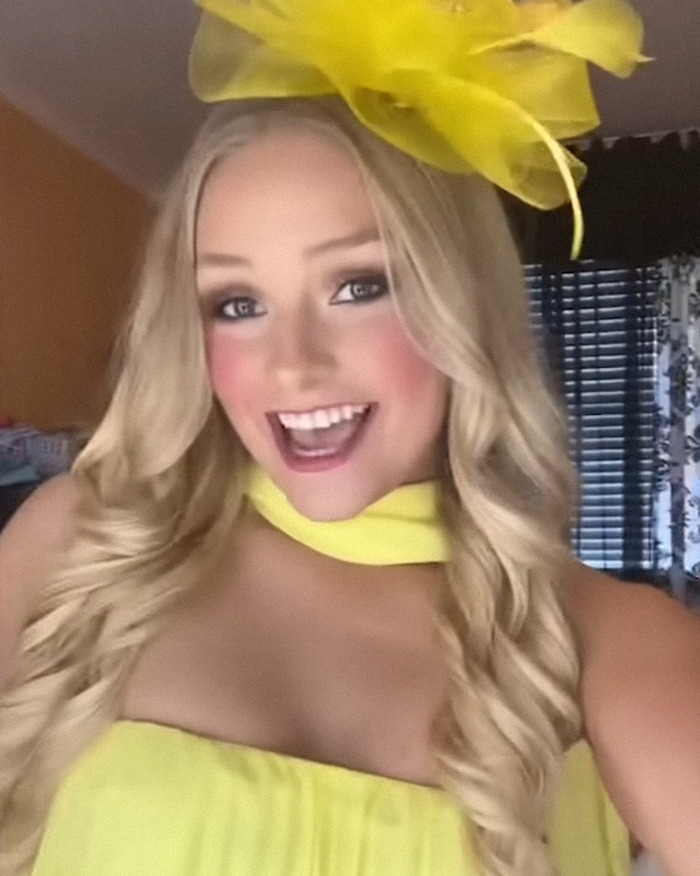 Young woman wearing a bright yellow dress and hat smiling inside a room, related to the Laken Snelling baby case news. Young woman wearing a bright yellow dress and hat smiling inside a room, related to the Laken Snelling baby case news.