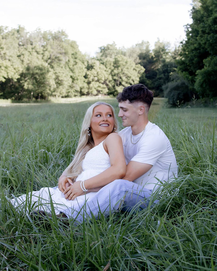 Young couple sitting in a grassy field, relating to the Laken Snelling baby case as new evidence sparks public fury. Young couple sitting in a grassy field, relating to the Laken Snelling baby case as new evidence sparks public fury.