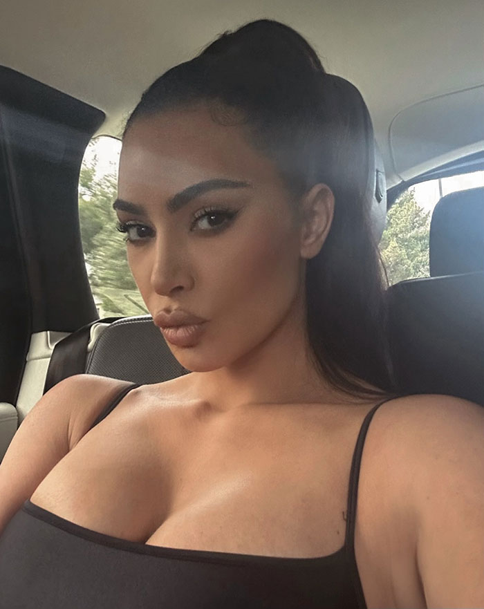 Woman with dark hair in a high ponytail wearing a black tank top, highlighting Kanye West’s warning about online life risks. Woman with dark hair in a high ponytail wearing a black tank top, highlighting Kanye West’s warning about online life risks.