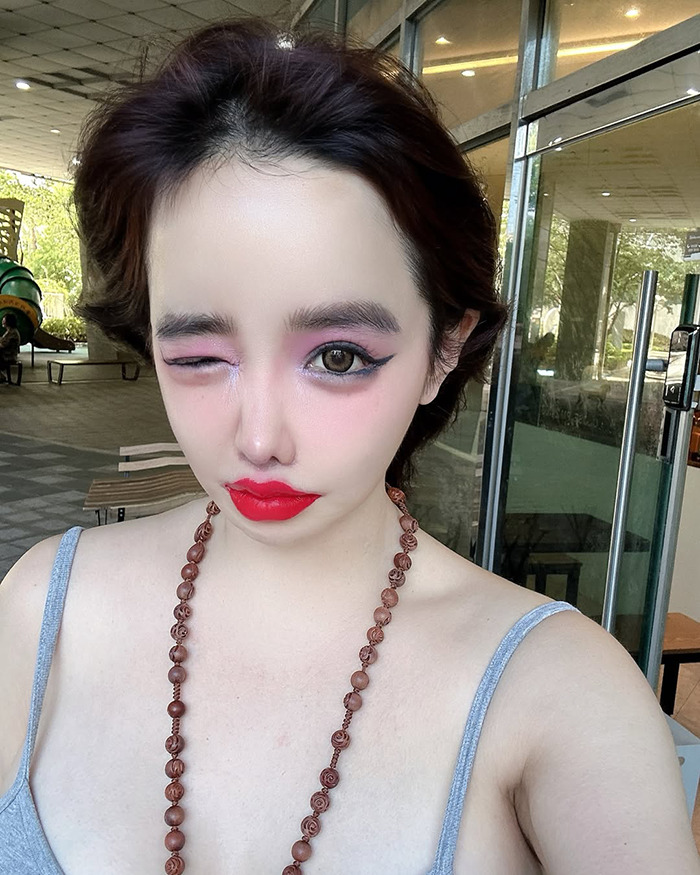 K-Pop icon Park Bom with bold makeup and a dramatic look, highlighting her drastic plastic surgery transformation. K-Pop icon Park Bom with bold makeup and a dramatic look, highlighting her drastic plastic surgery transformation.